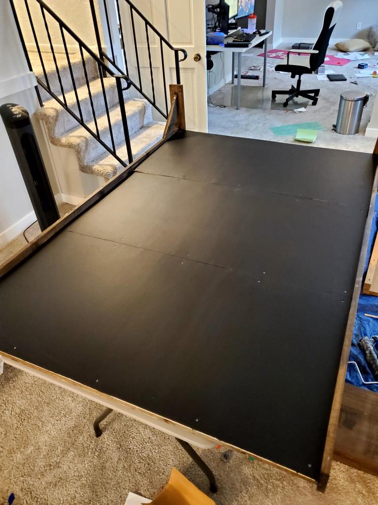 The plywood chalkboard sheets attached to the frame.